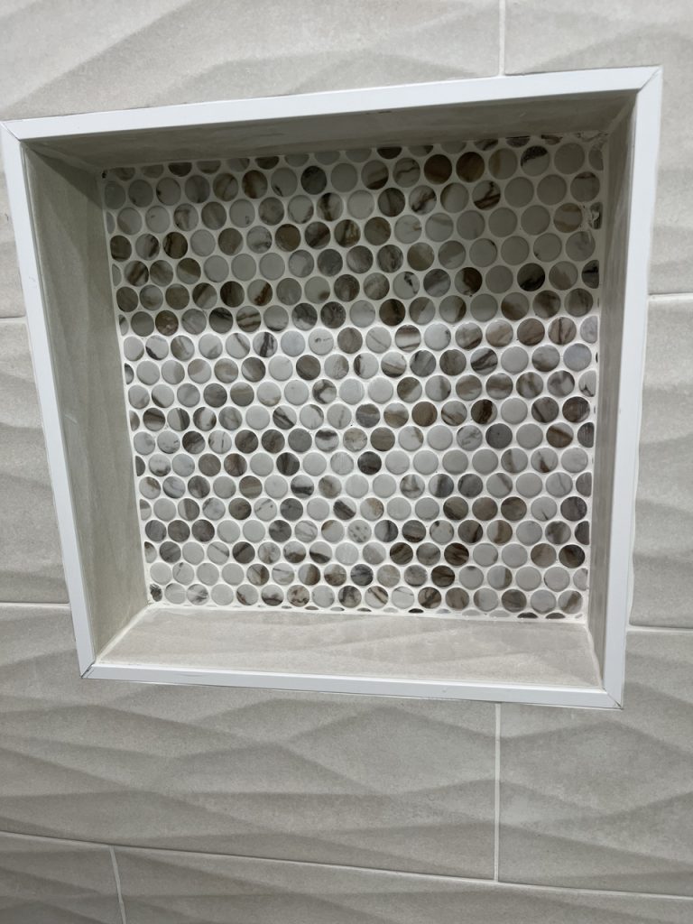 tile portion of a shower wall with a square cut out