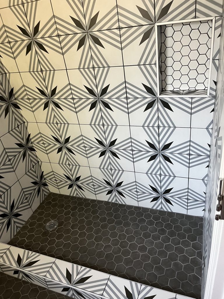 shower with unique design tile with black and white coloring